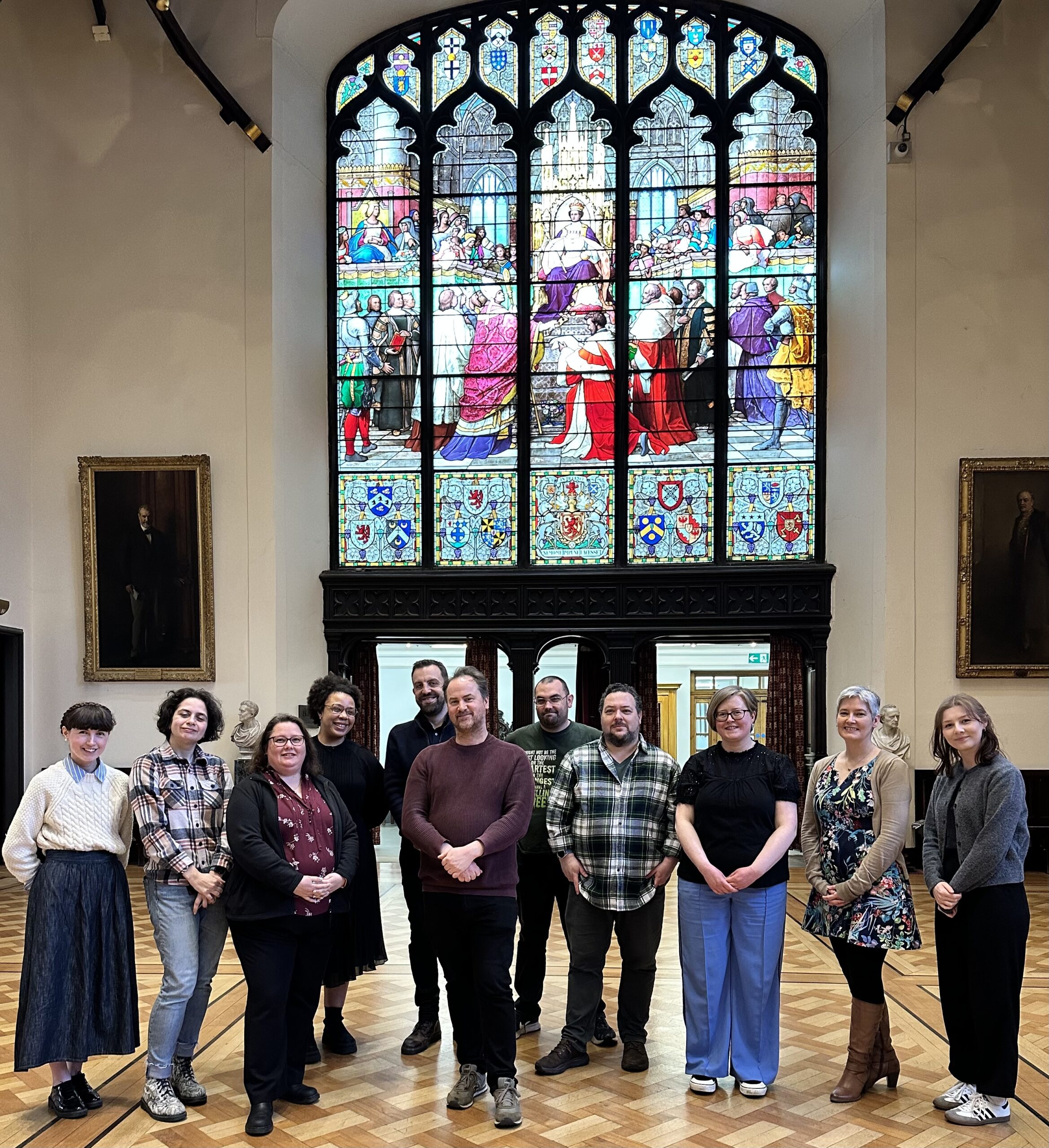 The CILIPS Trustee Board 2024 in front of a stained glass window at the Supreme Courts Library.