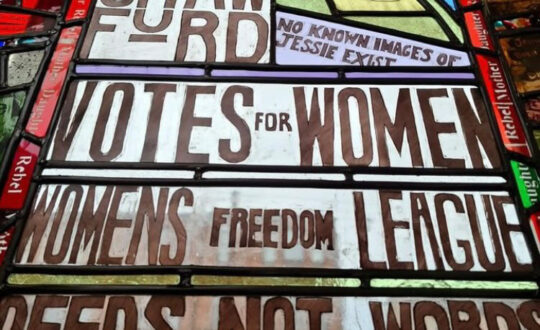 Suffragette Window showing Helen Crawford and Jessie Soga with text including 'votes for women, womens freedom league and deeds not words.'