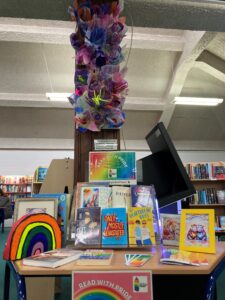 A rainbow book display inspired by Mayfield Secret Garden at Stirling Libraries.