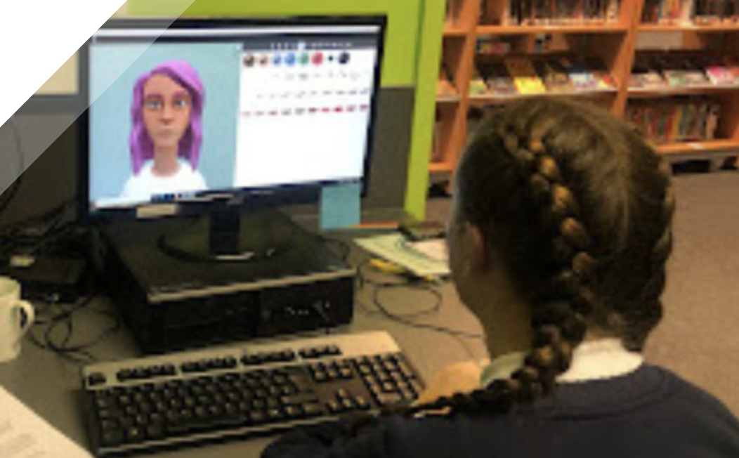 The back of a school child's head as they watch a Maddie is online video on a school computer in the library.