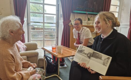 Pupils from Elgin Academy intergenerational reading with Anderson’s Care Home residents.